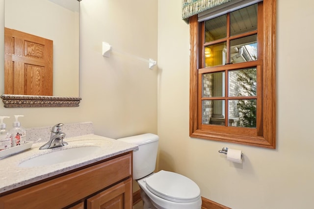 bathroom with toilet and vanity