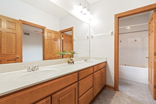 full bathroom with double vanity, washtub / shower combination, and tile patterned flooring