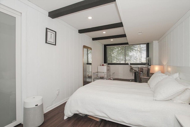 bedroom featuring wood finished floors and beamed ceiling