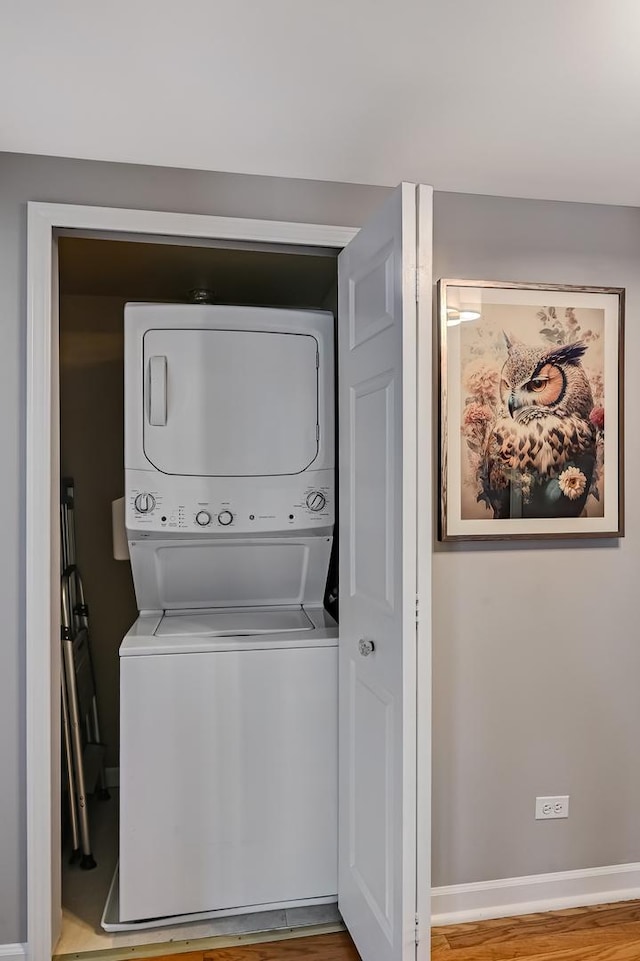 75 E Harris Ave Unit 2E, La Grange, IL 60525 - washroom with stacked washer and clothes dryer and baseboards