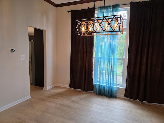 unfurnished dining area featuring wood finished floors, baseboards, and a chandelier