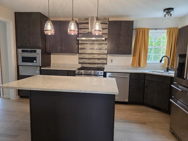 kitchen with stainless steel appliances, a sink, island range hood, light wood-type flooring, and dark brown cabinetry