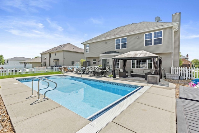 view of swimming pool with outdoor lounge area, a patio area, and a gazebo