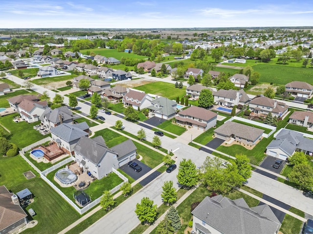 aerial view of property and surrounding area featuring nearby suburban area