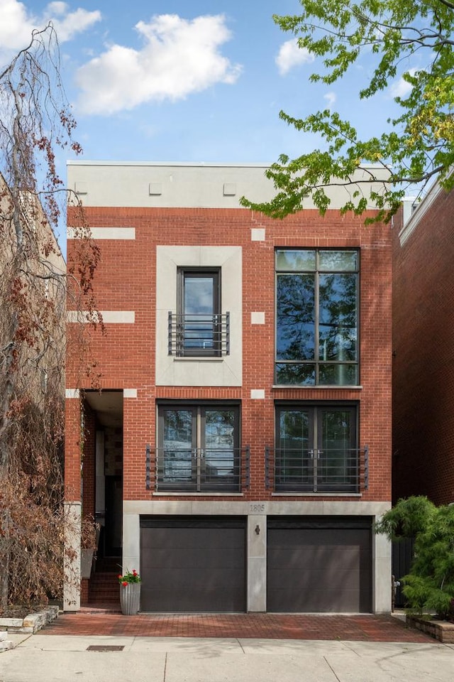 1805 N Paulina St, Chicago, IL 60622 - view of front facade with an attached garage, driveway, and brick siding