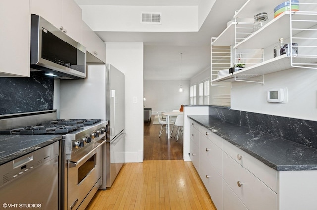 731 W Buckingham Pl Unit 12, Chicago, IL 60657 - kitchen with appliances with stainless steel finishes, open shelves, light wood-type flooring, white cabinetry, and decorative backsplash