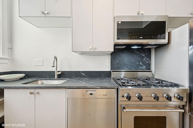 731 W Buckingham Pl Unit 12, Chicago, IL 60657 - kitchen with appliances with stainless steel finishes, a sink, white cabinetry, and dark stone countertops
