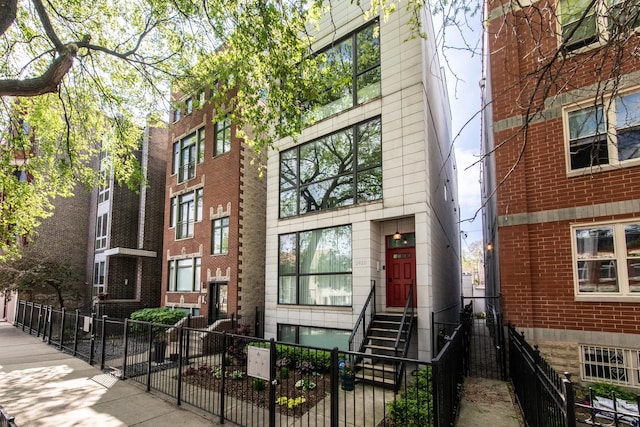view of property featuring a fenced front yard and entry steps
