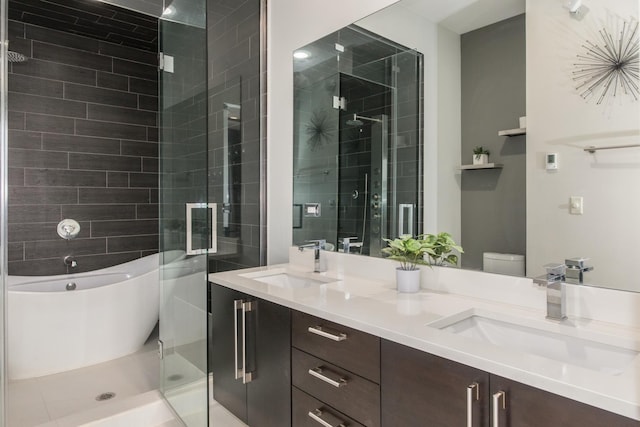 bathroom featuring a stall shower, double vanity, and a freestanding tub