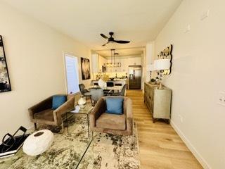 619 N Homan Ave, Chicago, IL 60624 - living room featuring ceiling fan, light wood-style flooring, and baseboards