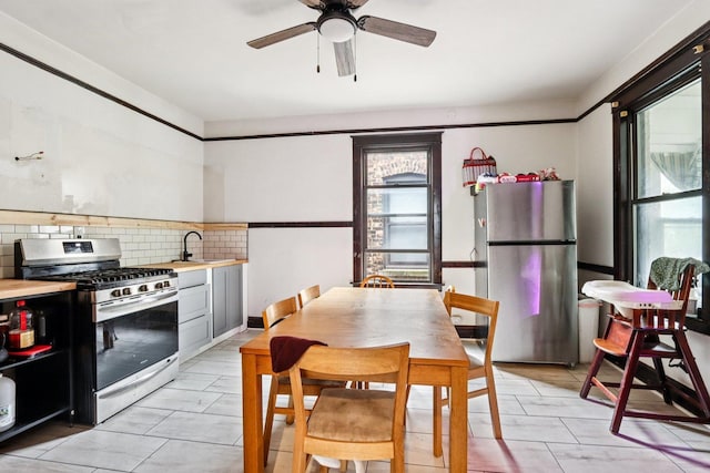 8548 S Manistee Ave, Chicago, IL 60617 - kitchen featuring stainless steel appliances, healthy amount of natural light, tasteful backsplash, and light countertops