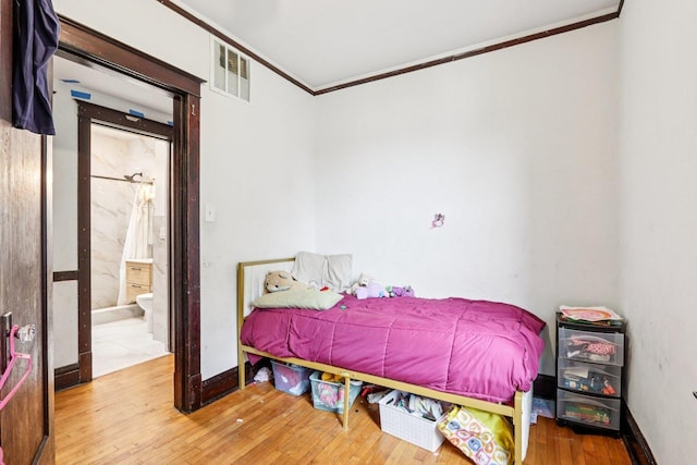 8548 S Manistee Ave, Chicago, IL 60617 - bedroom with ornamental molding, wood-type flooring, connected bathroom, and baseboards
