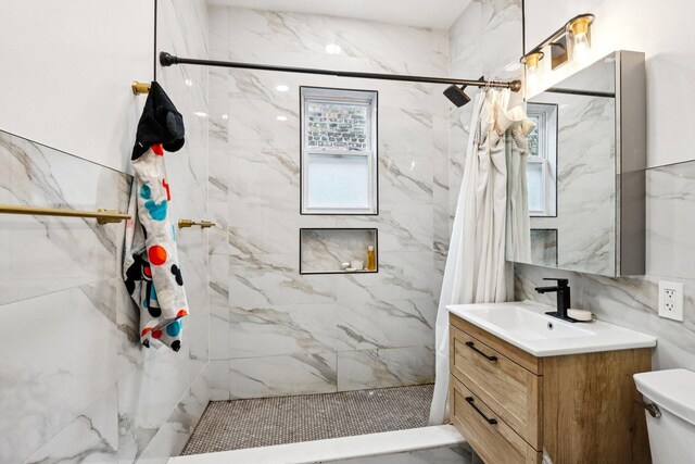8548 S Manistee Ave, Chicago, IL 60617 - bathroom featuring vanity, a tile shower, toilet, and healthy amount of natural light