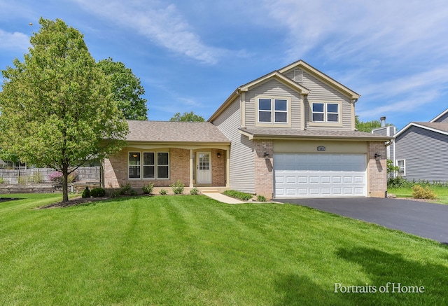 traditional-style home featuring asphalt driveway, an attached garage, brick siding, and a front lawn