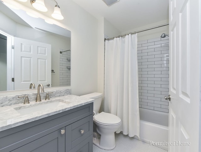 bathroom featuring tile patterned floors, toilet, vanity, and shower / bathtub combination with curtain