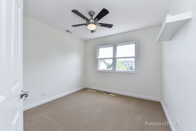 empty room featuring carpet flooring, baseboards, and ceiling fan