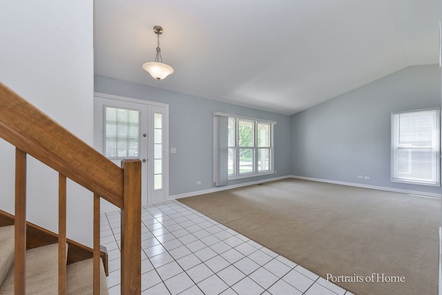 foyer with carpet, lofted ceiling, tile patterned flooring, baseboards, and stairs