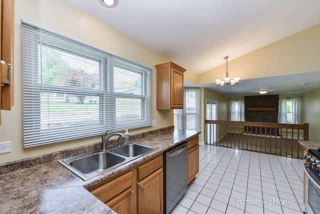 kitchen with stainless steel appliances, a sink, vaulted ceiling, light tile patterned flooring, and a chandelier