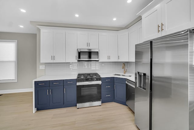9331 S Turner Ave, Evergreen Park, IL 60805 - kitchen with stainless steel appliances, a sink, white cabinetry, blue cabinets, and recessed lighting
