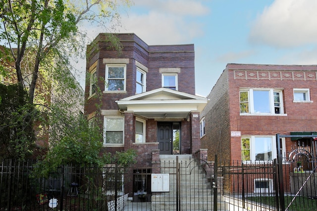 1002 N Drake Ave, Chicago, IL 60651 - view of front of house with a gate, brick siding, and a fenced front yard