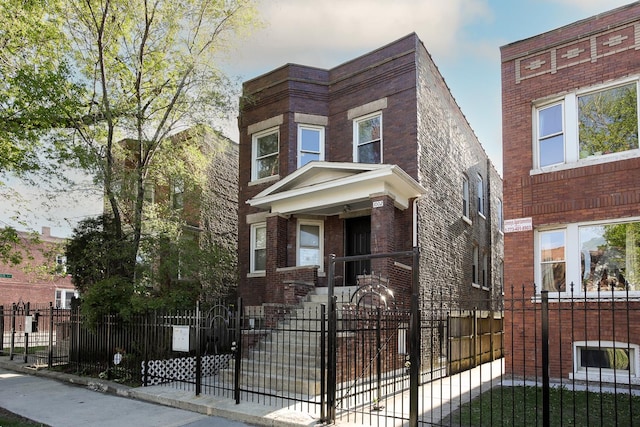 1002 N Drake Ave, Chicago, IL 60651 - view of front facade with a fenced front yard and brick siding