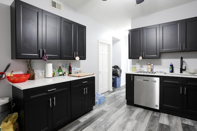 1002 N Drake Ave, Chicago, IL 60651 - kitchen featuring stainless steel dishwasher, a sink, and dark cabinetry