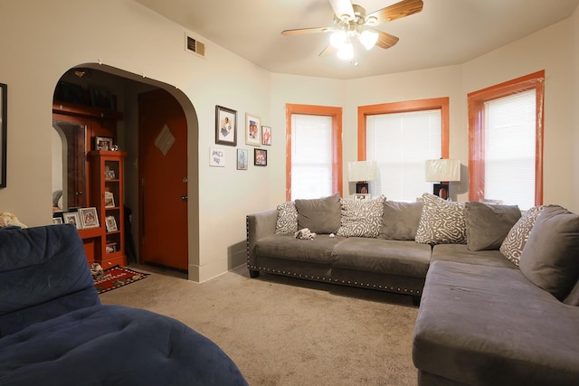 1002 N Drake Ave, Chicago, IL 60651 - carpeted living room with arched walkways and a ceiling fan