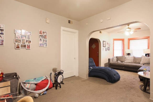 1002 N Drake Ave, Chicago, IL 60651 - living area featuring arched walkways, carpet floors, and a ceiling fan