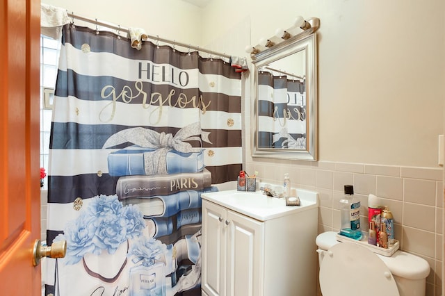 1002 N Drake Ave, Chicago, IL 60651 - bathroom with toilet, vanity, curtained shower, tile walls, and a wainscoted wall