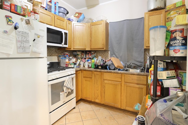 1002 N Drake Ave, Chicago, IL 60651 - kitchen featuring white appliances, backsplash, light tile patterned flooring, a sink, and light countertops