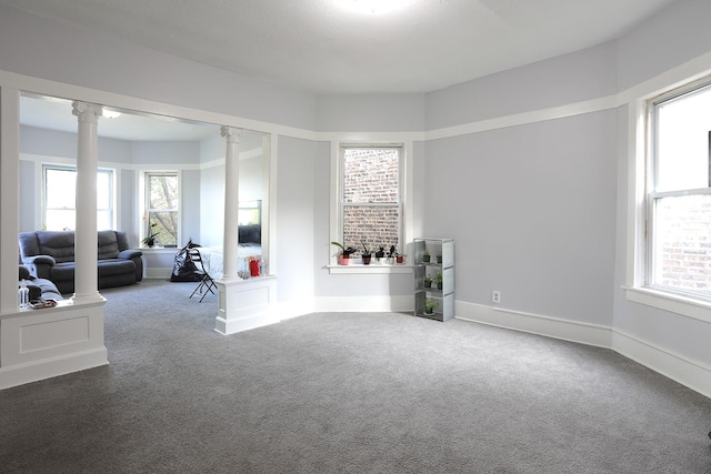 1002 N Drake Ave, Chicago, IL 60651 - spare room featuring decorative columns, carpet floors, and baseboards