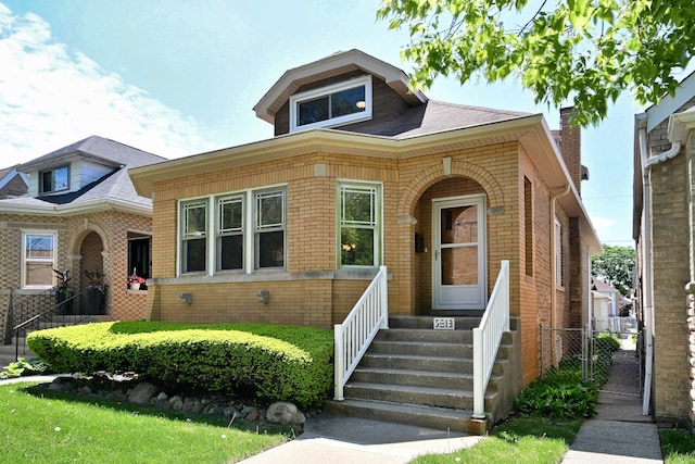 5813 W Eastwood Ave, Chicago, IL 60630 - bungalow featuring brick siding, a gate, and fence