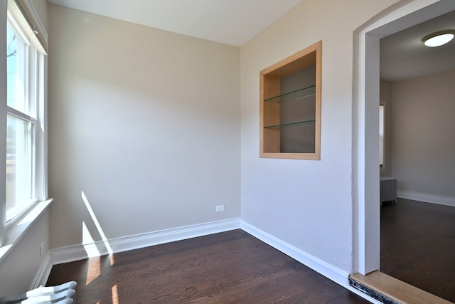 5813 W Eastwood Ave, Chicago, IL 60630 - spare room with radiator, dark wood finished floors, baseboards, and built in shelves