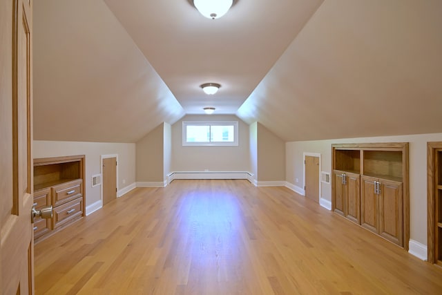 5813 W Eastwood Ave, Chicago, IL 60630 - additional living space featuring baseboard heating, light wood-style floors, lofted ceiling, and baseboards