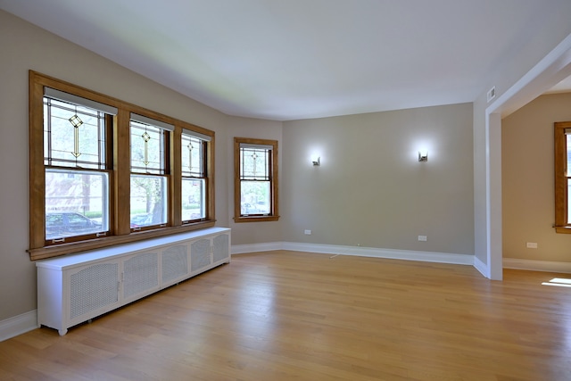 5813 W Eastwood Ave, Chicago, IL 60630 - spare room featuring radiator heating unit, light wood-style floors, and baseboards