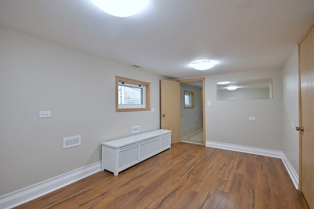 5813 W Eastwood Ave, Chicago, IL 60630 - empty room with wood finished floors and baseboards