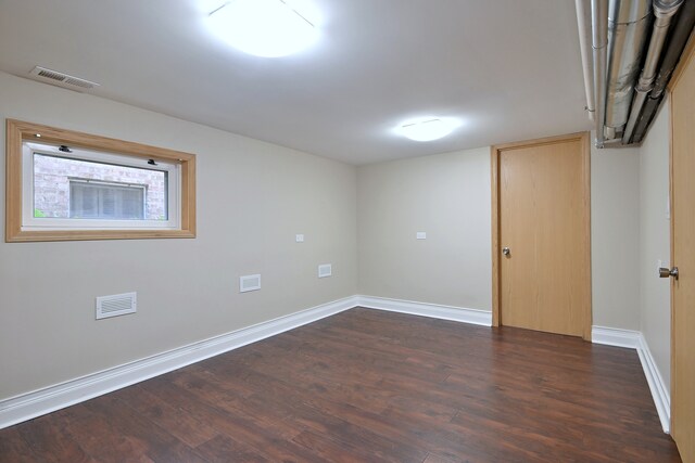 5813 W Eastwood Ave, Chicago, IL 60630 - empty room with dark wood finished floors and baseboards
