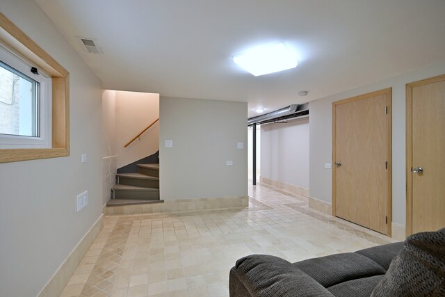 5813 W Eastwood Ave, Chicago, IL 60630 - living area with stairs, light tile patterned floors, and baseboards