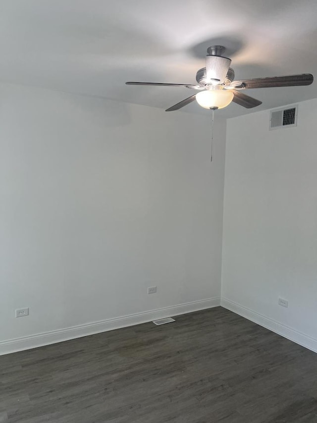 10642 S Calhoun Ave, Chicago, IL 60617 - spare room with ceiling fan, dark wood-style floors, and baseboards