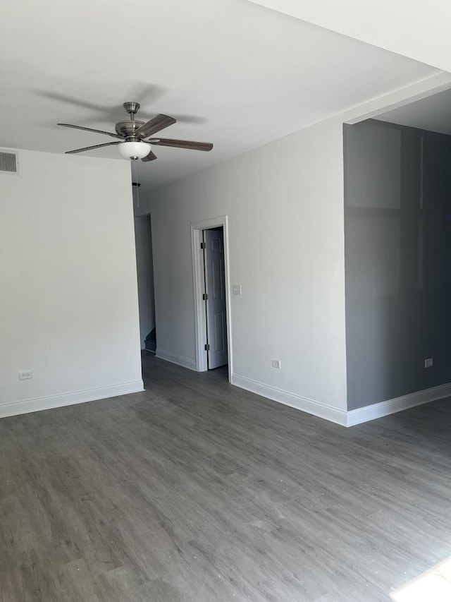 10642 S Calhoun Ave, Chicago, IL 60617 - empty room featuring a ceiling fan, dark wood-type flooring, and baseboards