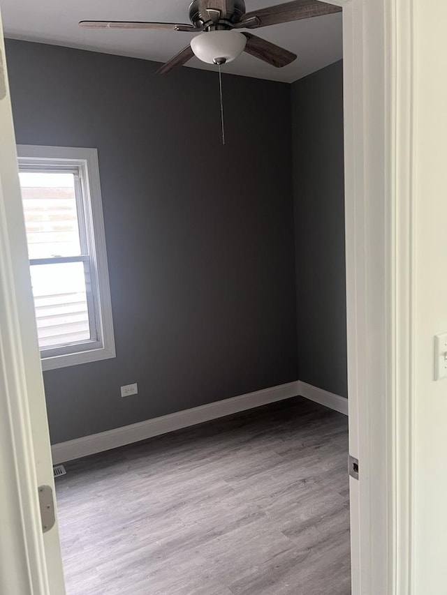 10642 S Calhoun Ave, Chicago, IL 60617 - spare room with ceiling fan, wood finished floors, and baseboards