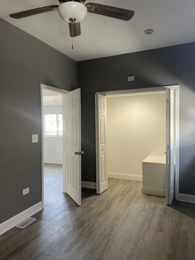 10642 S Calhoun Ave, Chicago, IL 60617 - empty room with a ceiling fan, wood finished floors, and baseboards