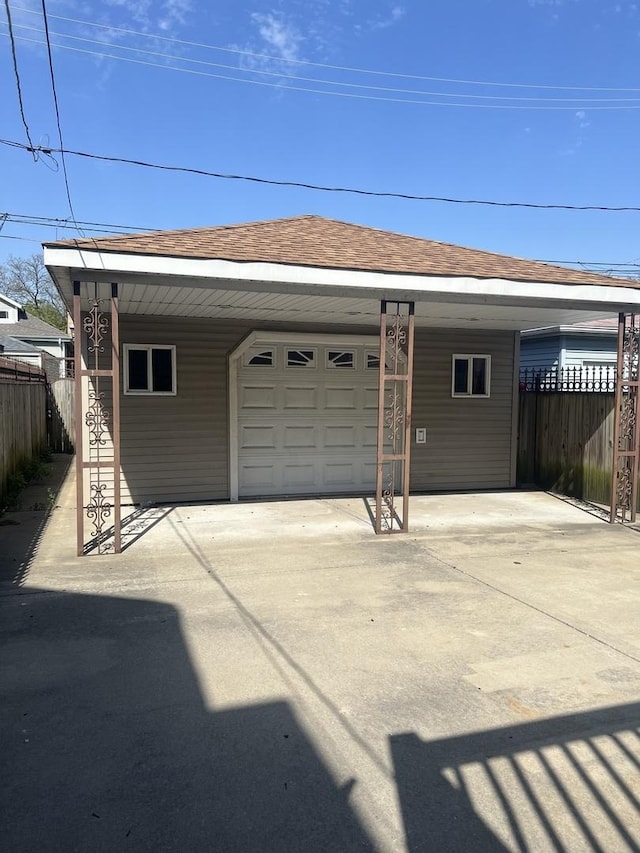 10642 S Calhoun Ave, Chicago, IL 60617 - garage with fence, concrete driveway, and an attached carport