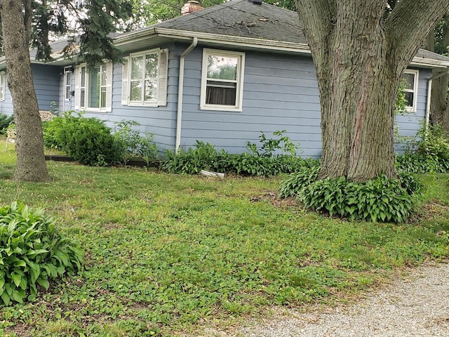 517 S Hebbard St, Joliet, IL 60433 - view of side of property featuring a chimney, a lawn, and a shingled roof