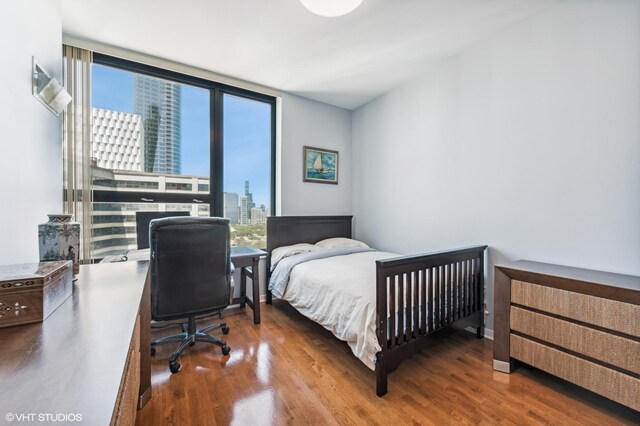 1160 S Michigan Ave Unit 3805, Chicago, IL 60605 - bedroom featuring wood finished floors, a city view, a desk, and a wall of windows