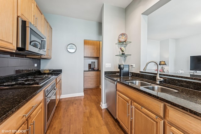 1160 S Michigan Ave Unit 3805, Chicago, IL 60605 - kitchen featuring appliances with stainless steel finishes, a sink, wood finished floors, dark stone counters, and baseboards
