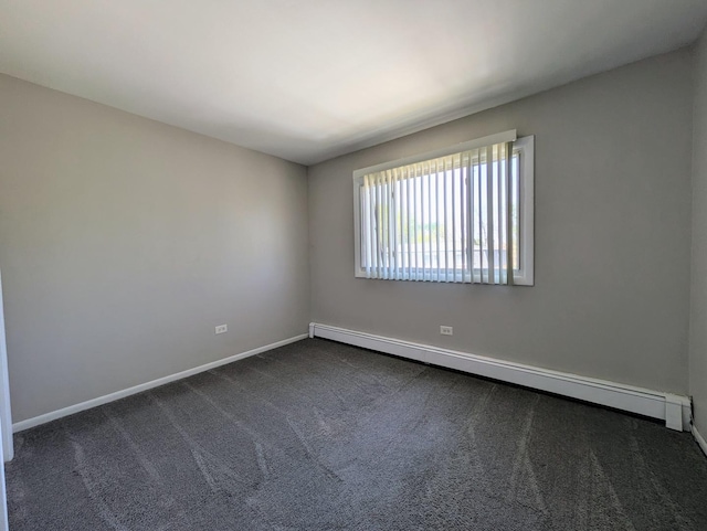unfurnished room with a baseboard heating unit, dark colored carpet, and baseboards