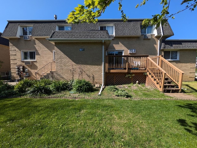 back of property featuring stairs, mansard roof, and brick siding
