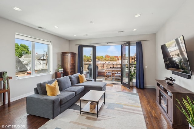 living room with wood finished floors, recessed lighting, and baseboards