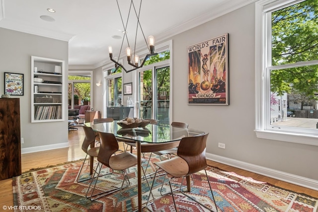 dining area with crown molding, wood finished floors, baseboards, a chandelier, and recessed lighting